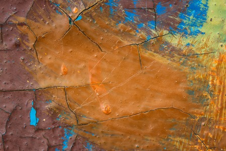 bright abstraction colorful paint and dark scratches covering the metal surface close-up artistic...