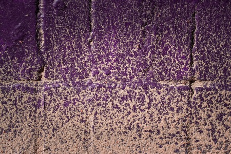texture of a violet wall from vintage tiles covered with bright sand forming patterns background for designの写真素材