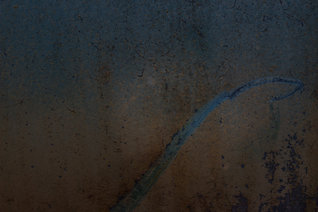 long scratch mysterious pattern on rusty metal surface close-up grunge background for design