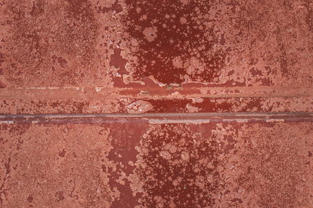 bright texture of a brown metal door covered with cracked film background for design an interesting...