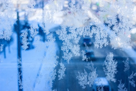 breathtaking ice texture on a frozen winter window bewitching patterns against the background of...