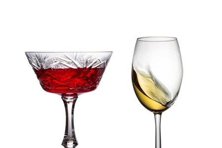 red wine in a vintage glass next to a glass with white wine alcohol concept objects for designの写真素材