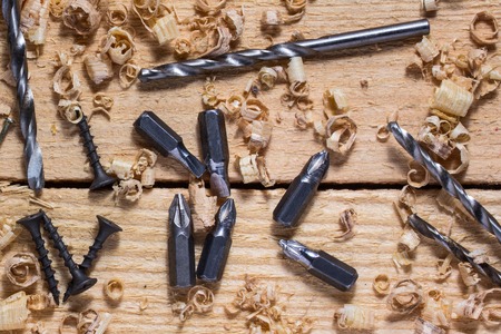 industrial still life metal working tools lie on a wooden table close-up with fine chips around the concept of woodworkingの写真素材