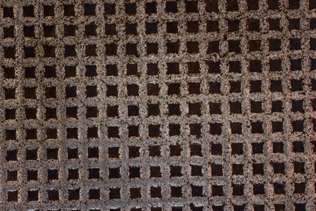 metal texture with dark squares patterns close-up background for design industry concept