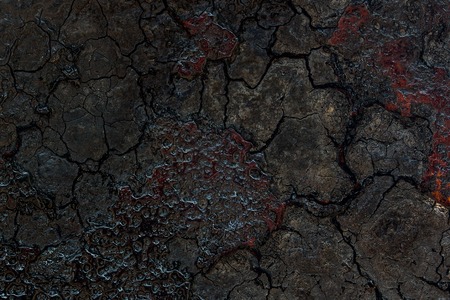 cracked dark pieces of soot on metal close-up background for designの写真素材