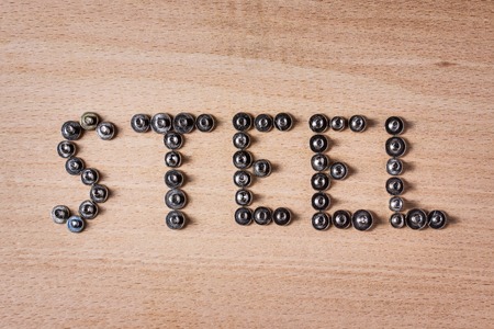 The word steel is lined with small metal screws in English Close-up Concept of tools and industryの写真素材