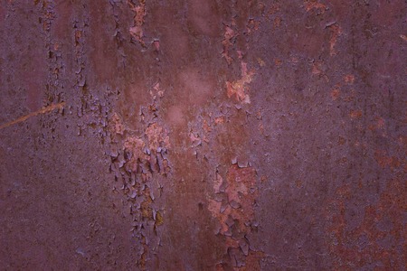 old rusted sheet of metal with partially peeling paint and exciting patterns close-up grunge background for design industry conceptの写真素材