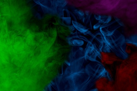 multicolored ghostly clouds of cigarette vapor mysterious abstraction for design concept smokingの写真素材