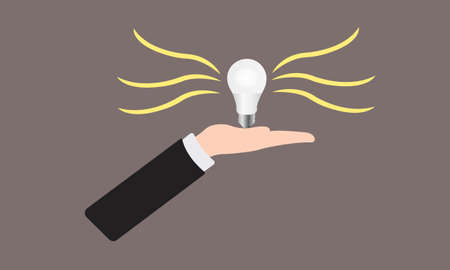 light bulb shines on the palm of a businessman in a business suit a symbol of ideaのイラスト素材