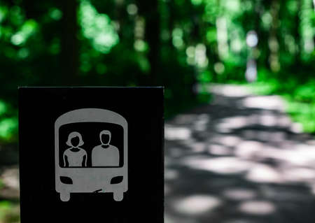 a warning sign in the park indicating the road on which the electric car is movingの写真素材