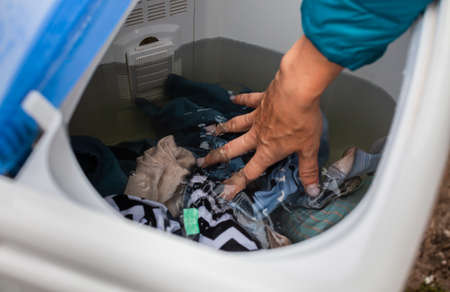 placing laundry in a washing machine in a tank filled with water. High quality photoの写真素材