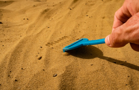 little kids rake on yellow sand background. High quality photoの写真素材