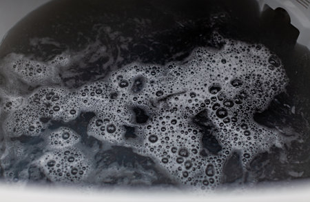 washing machine drum filled with water and foam. High quality photo