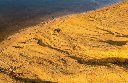 fragment of a sandy shore washed out by water. High quality photoの写真素材