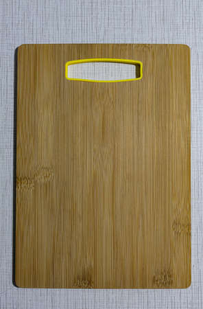 natural wood cutting board on a light background. High quality photoの写真素材