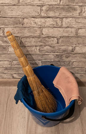 broom rag and gloves lying in a plastic bucketの写真素材
