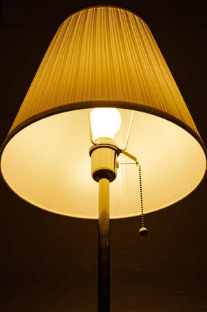 lighted lamp standing in the dark on the background of the wall. High quality photoの写真素材