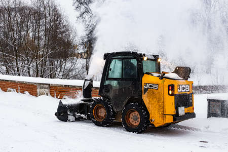 Moscow, Russia - December 07, 2021: a snowplow tractor rides the park alley. High quality photoのeditorial素材