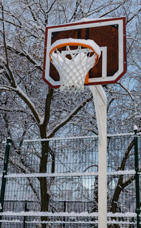 basketball hoop on the court covered with snow after a snowfall. High quality photoの写真素材