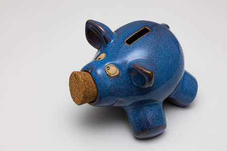 piggy bank in the shape of a blue pig made of ceramic. High quality photoの写真素材