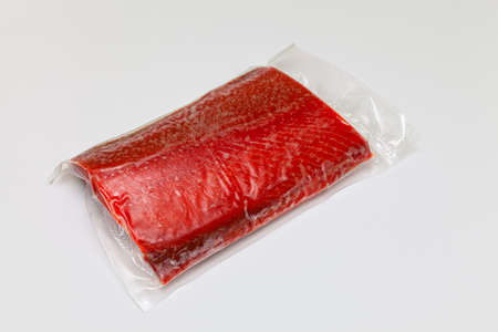 a piece of frozen red fish packed in a plastic blisterの写真素材