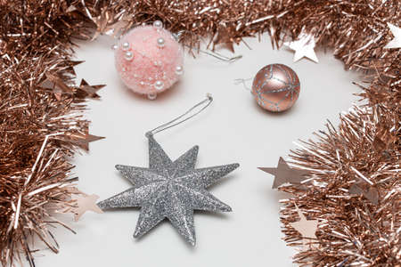 christmas decoration in the form of a star and a ball surrounded by tinsel