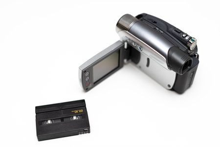 an old household video camera and a cassette for it lying nearby. high quality photoの写真素材