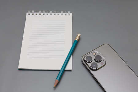 on the table lies a notebook, a pencil and a smartphone. high quality photoの写真素材