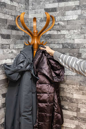 female hand hang clothes on a hanger. high quality photoの写真素材