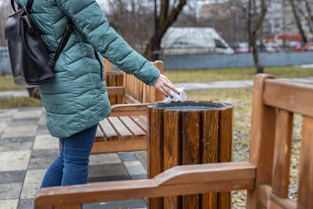 female hand throws a crumpledfemale hand throws a crumpled bag into the trash bag into the trash....