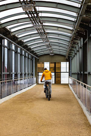 Moscow, Russia - April 20, 2022: a man rides a bicycle on crosswalkの写真素材