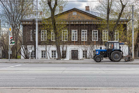 Moscow, Russia - May 01, 2022: wheeled tractor rides along the city street. high quality photoのeditorial素材