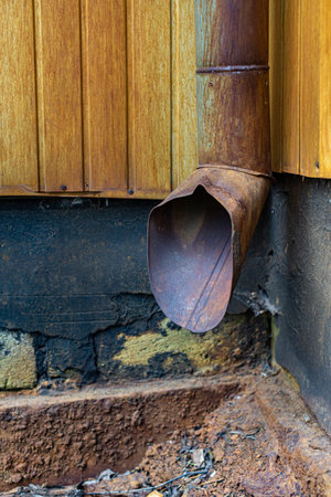 old rusty sewer on the wall of a building. high quality photo