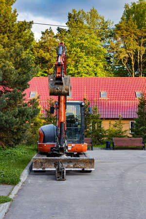Moscow, Russia - May 21, 2022: excavator stands in the yard of the house. high quality photoのeditorial素材