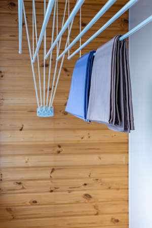 clothes dryer attached to the ceiling with clothes hanging. high quality photo