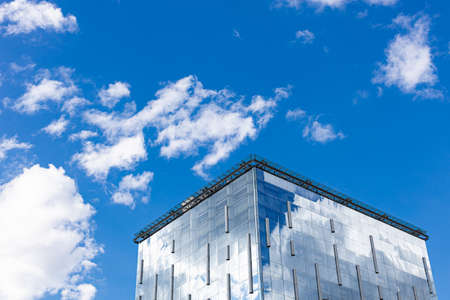 building with glass walls reflecting the sky. high quality photo