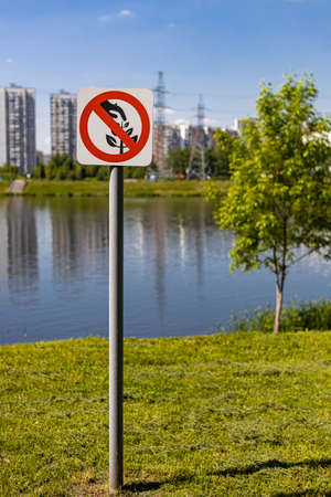 there is a sign on the grass forbidding picking plants. high quality photoの写真素材