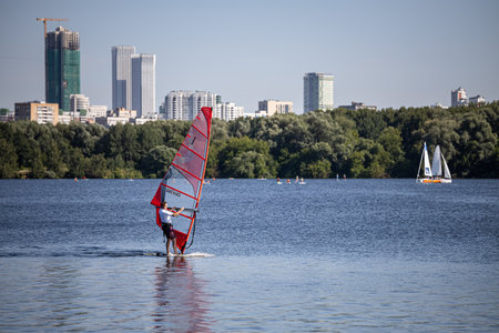 Moscow, Russia - July 01, 2022: man sailing on a sailboat, windsurfers. high quality photoのeditorial素材