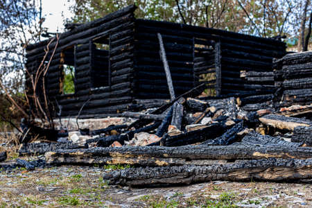 the remains of a burnt log house on the background of nature. high quality photoの写真素材