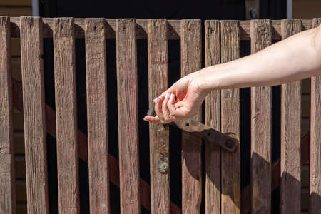 female hand opens the bolt on the tile. high quality photoの写真素材