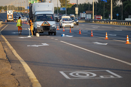Moscow, Russia - August 12, 2022:road worker applies road markings. high quality photo