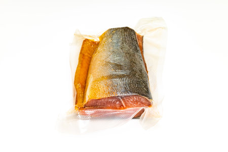 red fish in a transparent package on a white background. fish in a package.