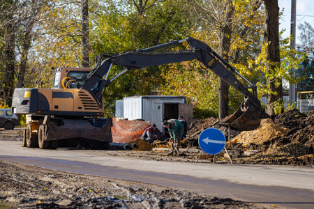 Novomoskovsk, Russia - October 07, 2022: road worker works with a shovel.