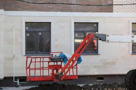 cradle construction hoist on the background of the house. construction hoist