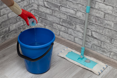 the cleaner adds detergent to the water. detergent is poured from the cap into a bucket of water