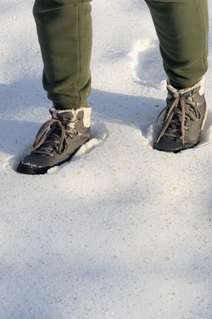 a man is falling through the snow. man walking in the snow. foot falls into the snow.
