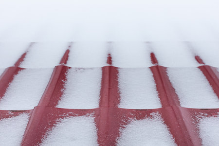 roof of a house covered with snow. house roof in winter.の写真素材