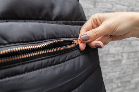 woman opens a zipper lock with her hand. man unzips a zipper. hand opens bag