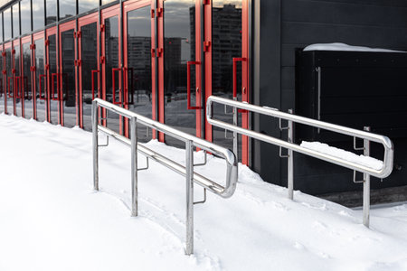 metal railing covered with snow in winter. snow covered stairs. metal railing