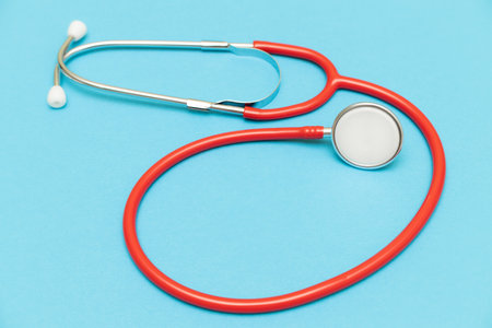 medical stethoscope on a blue background shot with blur. close-up shot of a stethoscope. medical...